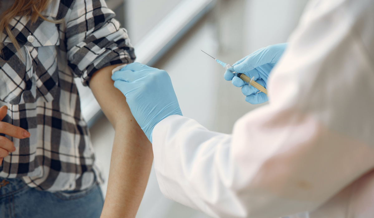 nurse injects patient with vaccine