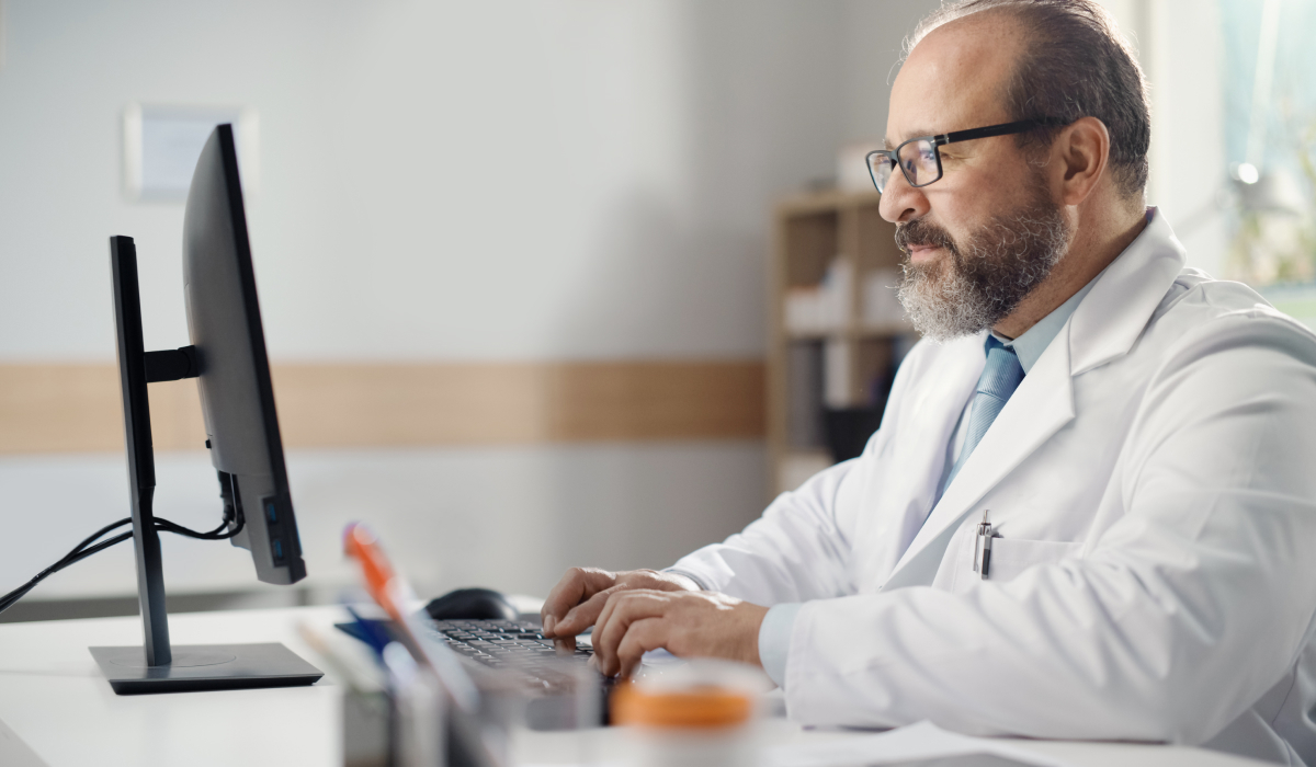 Doctor typing on a computer 