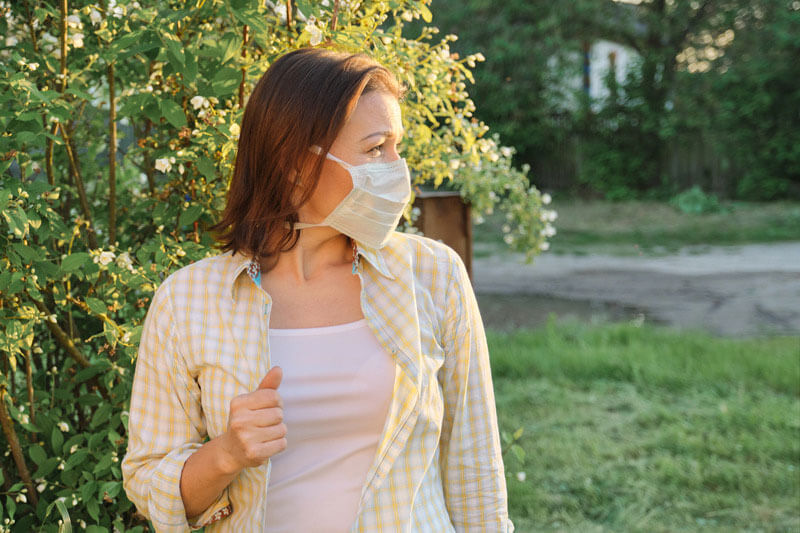 Woman walking with a mask 