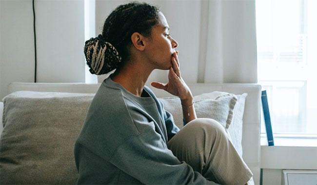 Women thinking on a bed 